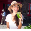 Valentina Cartago is a nutritional therapist who recommends noops nutropics to support cognative function. Valentina looks cheerful in a fashionable hat enjoys a refreshing green smoothie, showcasing her healthy lifestyle.