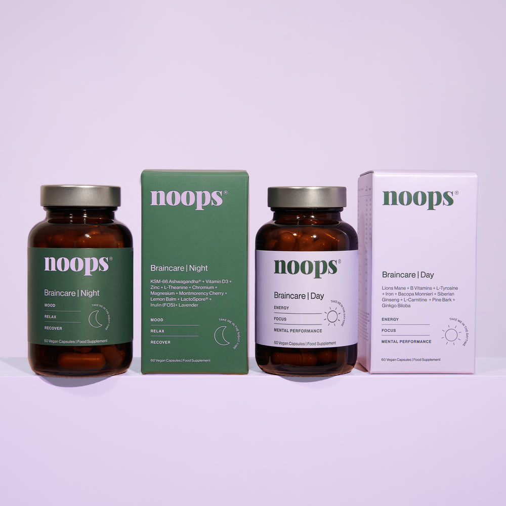 Two bottles of noops nootpropics Braincare supplements, one for Day and one for Night, with boxes. Use this vegan and science backed formula to support anxiety, sleep, focus and energy